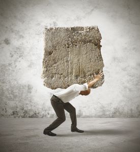 Man carrying boulder on his back.